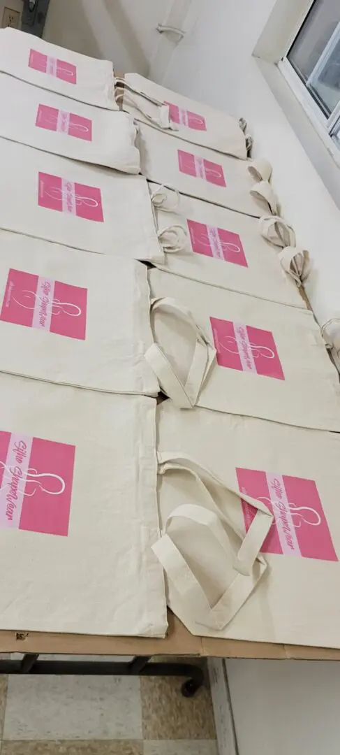 A bunch of bags with pink prints kept side by side on a table